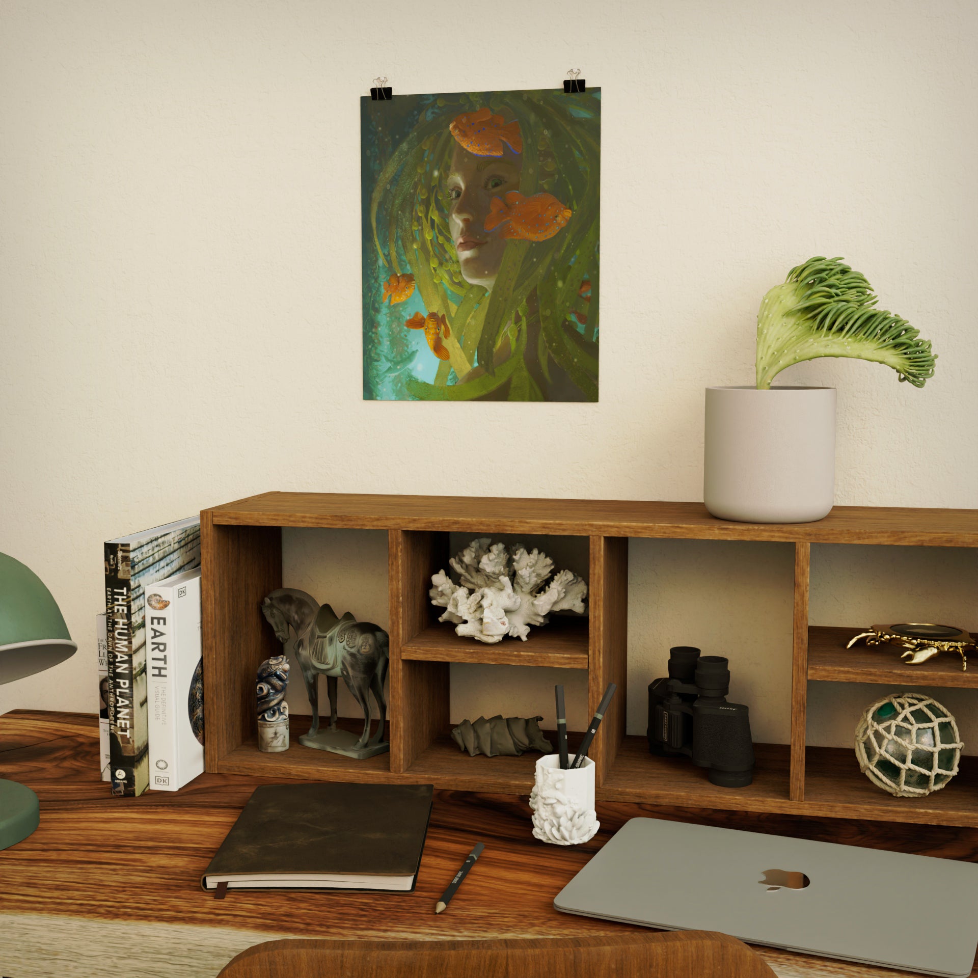 painting of a beautiful serene mermaid with kelp hair with brightly colored fish swimming nearby. poster is hung on wall over a desk with ocean themed decorative items
